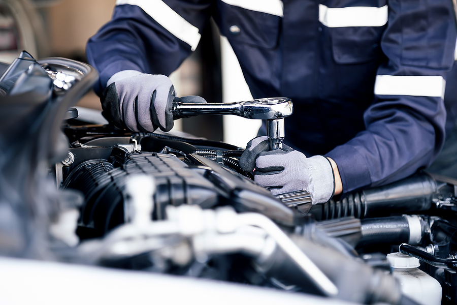 Professional Mechanic Working On The Engine Of The Car In The Garage